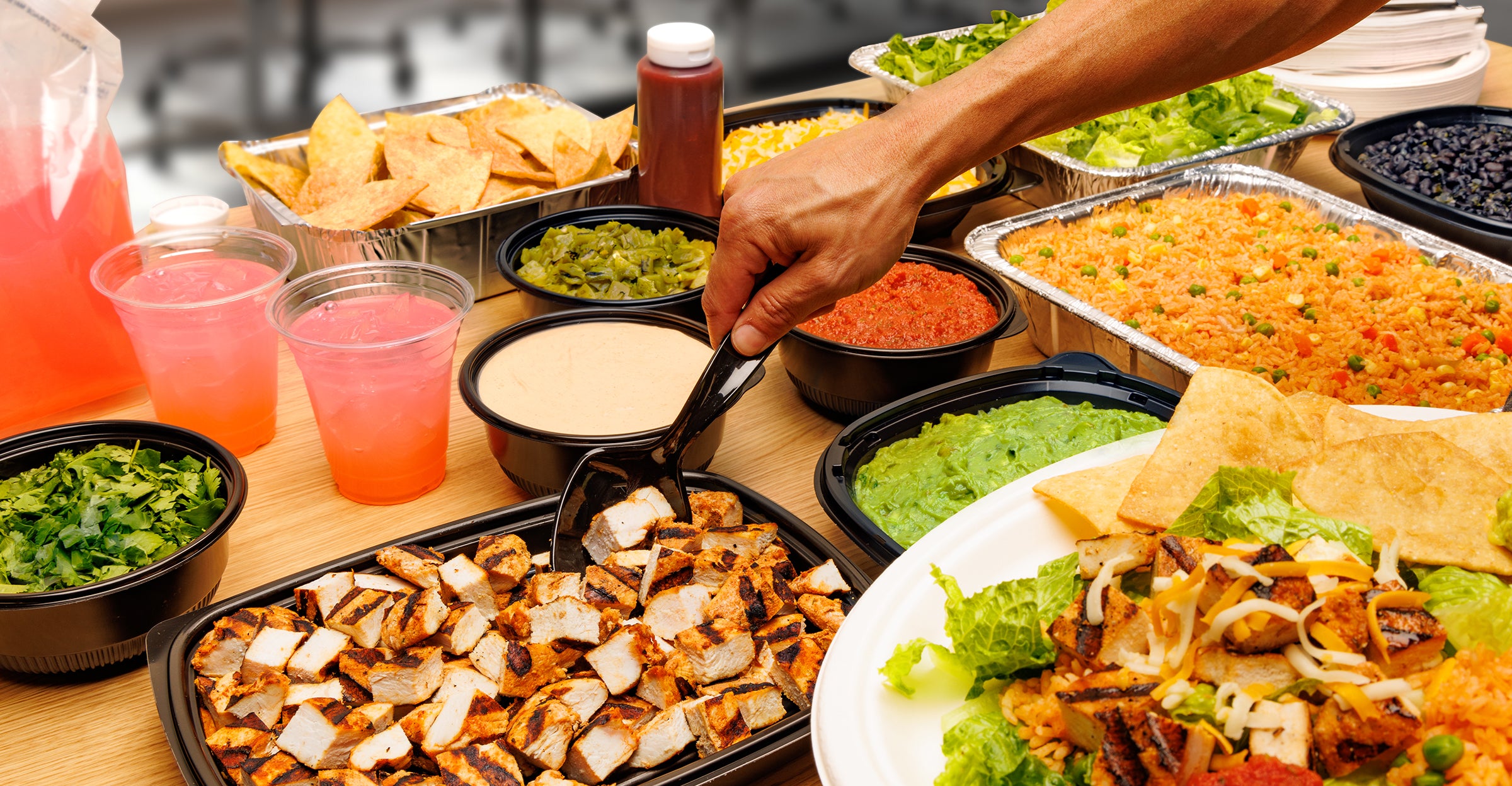 Dessert platter with cookies, chocolate bars, and a cake, accompanied by a glass of milk.
