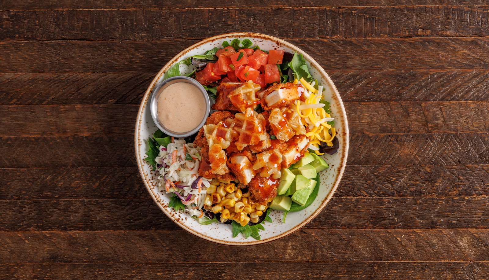 Plate of Hot Honey Chicken + Waffle Salad Roadtrip Bowl